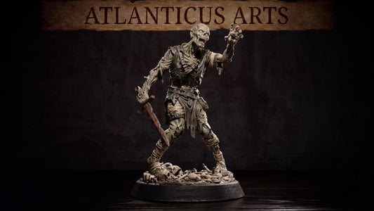 Wide shot of the painted zombie resin miniature holding a rusty sword on a dark wooden tabletop.