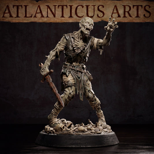 Close-up of a painted rotting Zombie miniature holding a rusty sword and reaching forward, standing on a base covered in bones under the Atlanticus Arts banner.